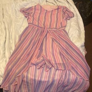 A dress with shorts in them that is striped pink and purple has zip on the back